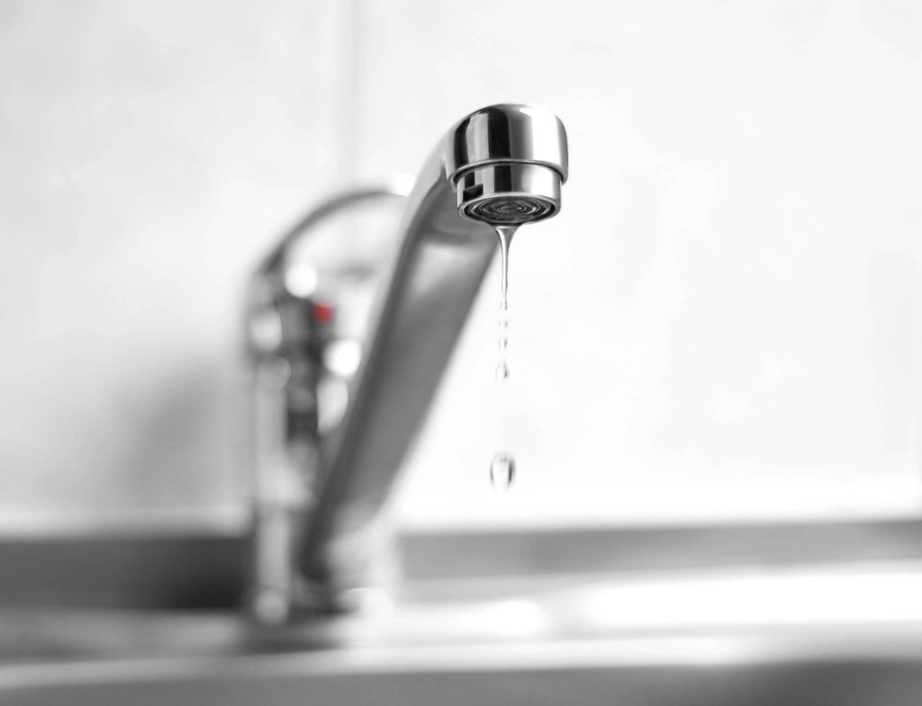 water is dripping from metal tap