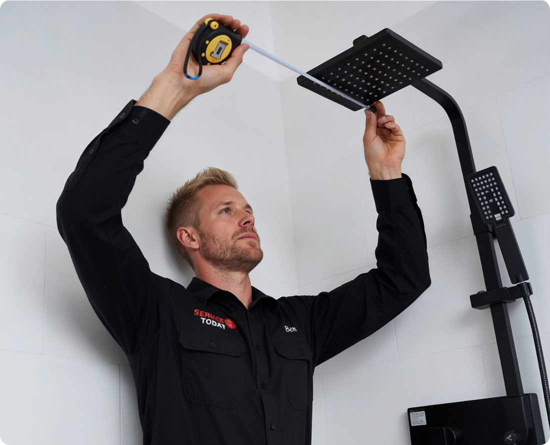 Plumber measuring for shower repair.